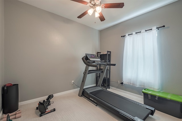 workout room with ceiling fan and light carpet