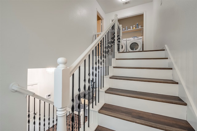 staircase featuring independent washer and dryer