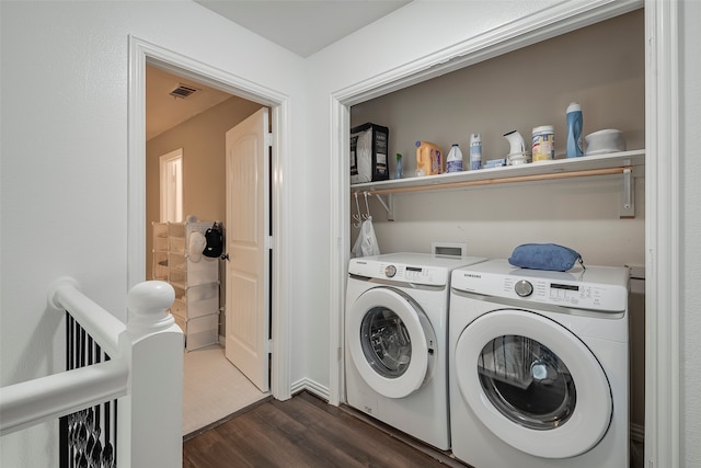 washroom featuring dark hardwood / wood-style floors and separate washer and dryer