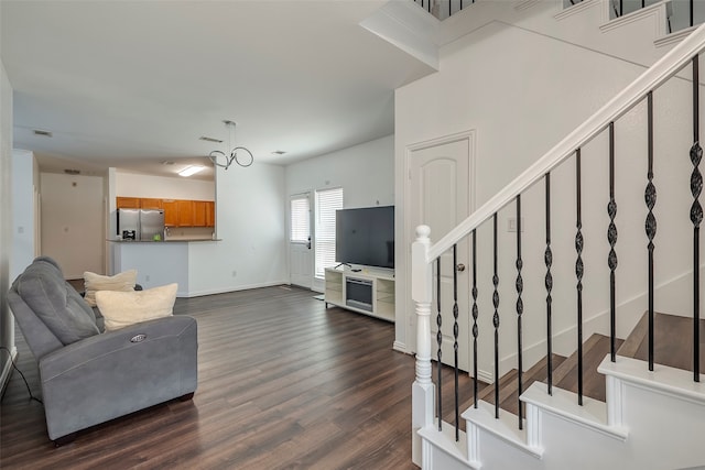 living room featuring a chandelier and dark hardwood / wood-style floors