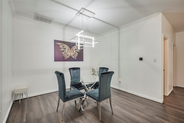 dining space with hardwood / wood-style floors and crown molding