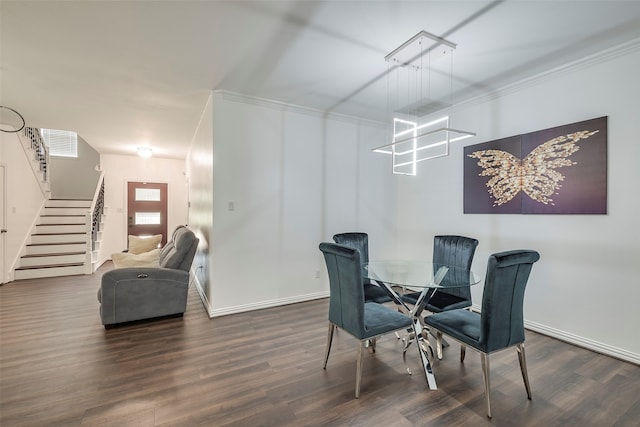 dining space featuring dark hardwood / wood-style floors and crown molding