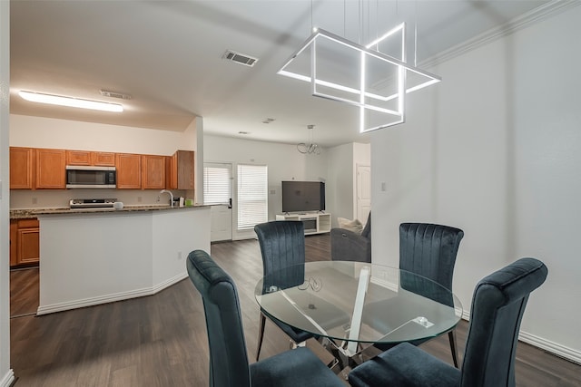 dining area with dark hardwood / wood-style floors and sink