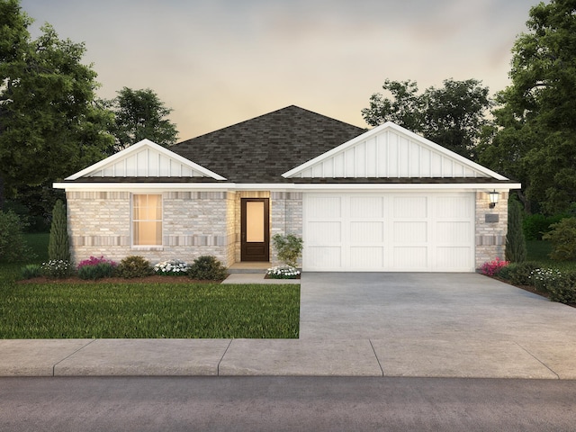 view of front of home with a yard and a garage