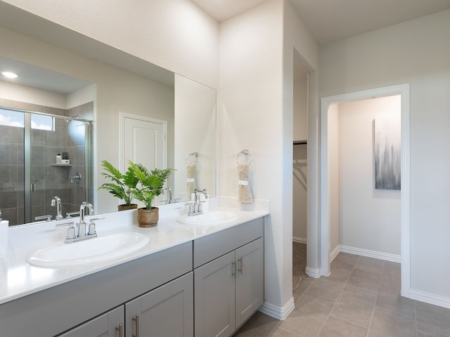 bathroom featuring tile patterned floors, vanity, and a shower with shower door