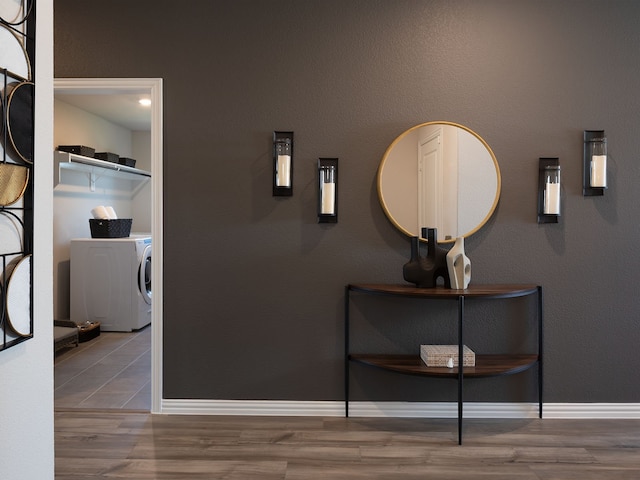 corridor with washer / dryer and hardwood / wood-style flooring