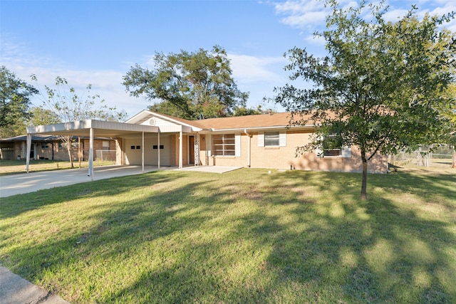 back of house featuring a lawn and a carport