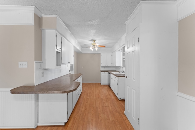 kitchen featuring white cabinetry, light hardwood / wood-style flooring, and sink