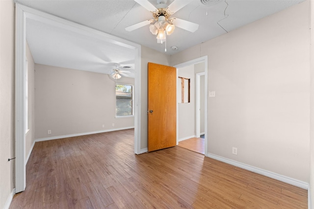 unfurnished room featuring ceiling fan and light wood-type flooring