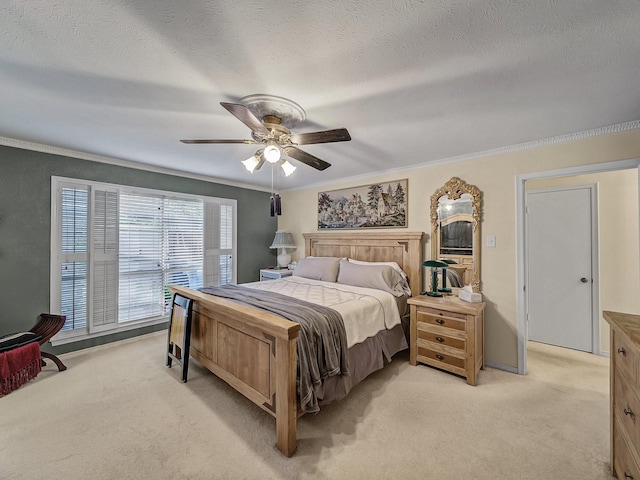 bedroom featuring crown molding, light colored carpet, and a textured ceiling