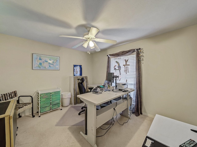 carpeted office space with ceiling fan and a textured ceiling