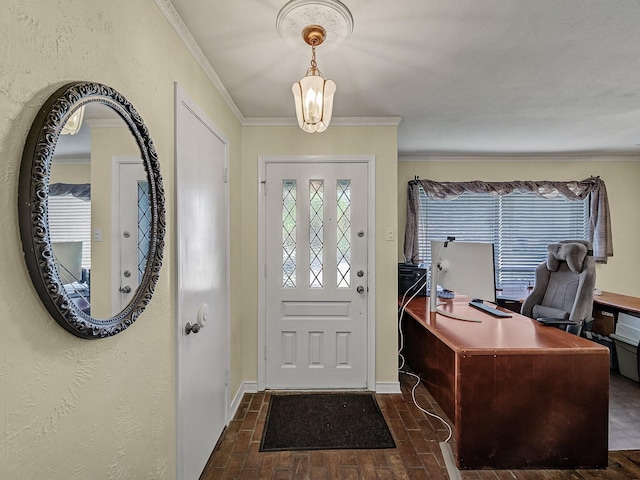 entryway featuring a notable chandelier and ornamental molding