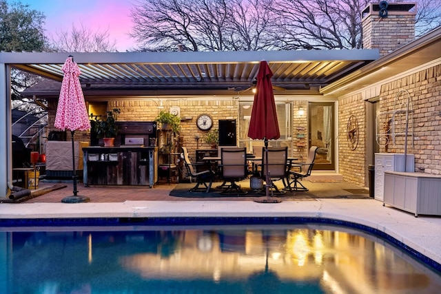 pool at dusk featuring a patio area