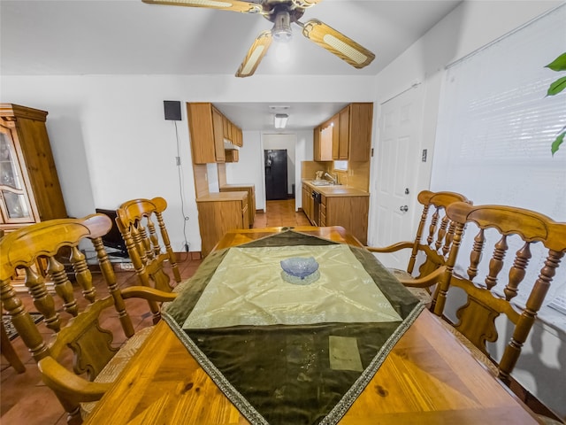 dining room featuring ceiling fan and sink