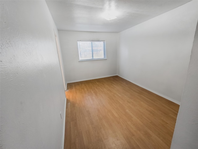 spare room featuring light hardwood / wood-style flooring