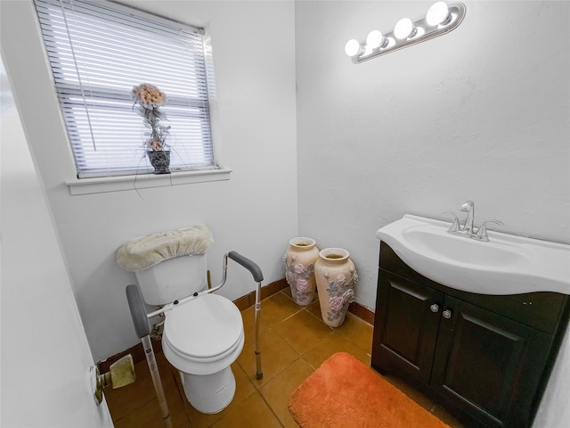 bathroom featuring tile patterned flooring, vanity, and toilet