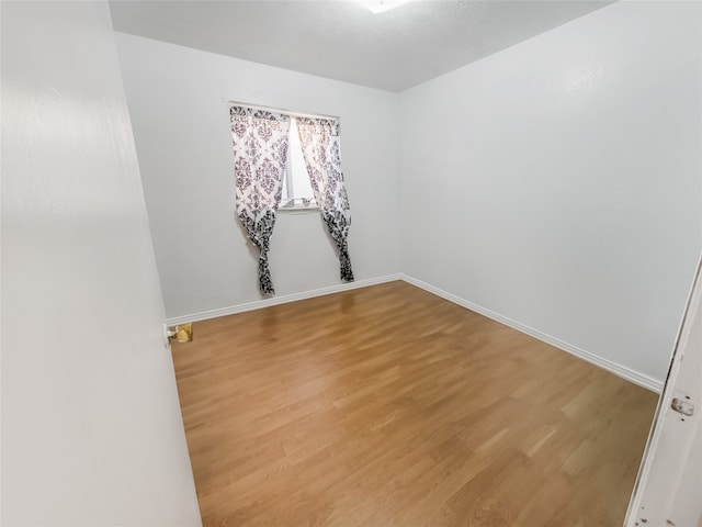 spare room with hardwood / wood-style flooring