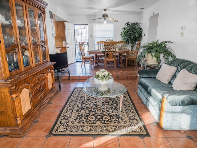 tiled living room with ceiling fan