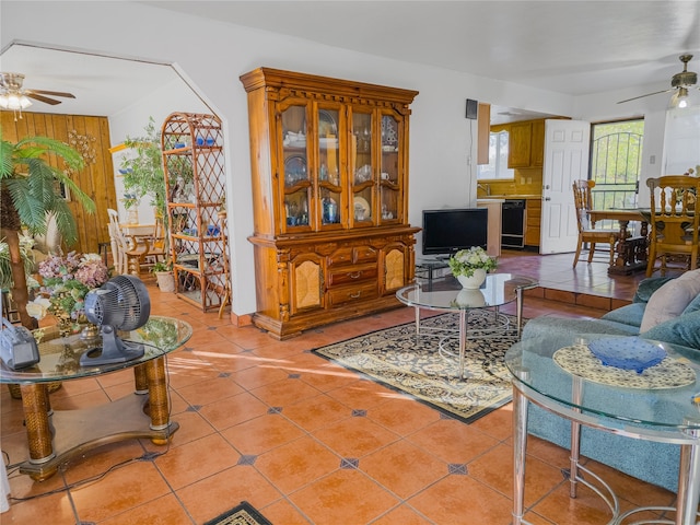 tiled living room featuring wine cooler and ceiling fan