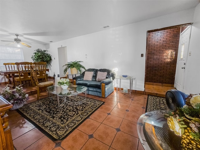 tiled living room with ceiling fan