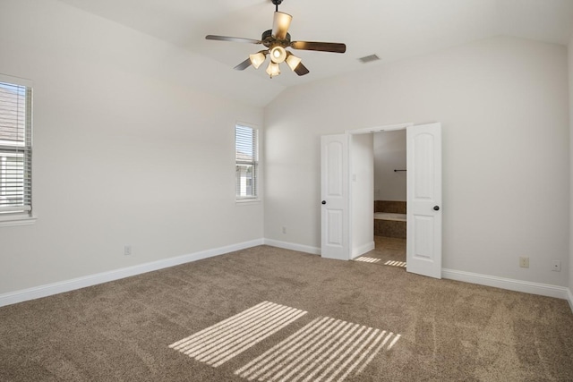 unfurnished bedroom featuring ceiling fan, lofted ceiling, and carpet floors