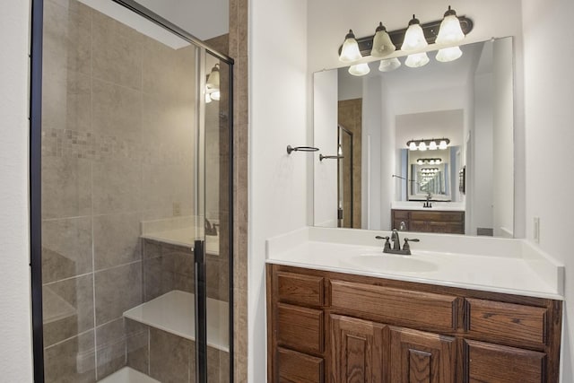 bathroom with vanity and a shower with shower door