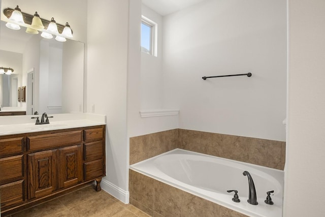 bathroom featuring tile patterned floors, tiled bath, and vanity