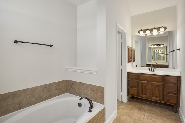 bathroom featuring tile patterned floors, vanity, and tiled tub