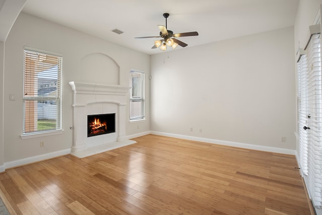 unfurnished living room featuring ceiling fan and light hardwood / wood-style floors