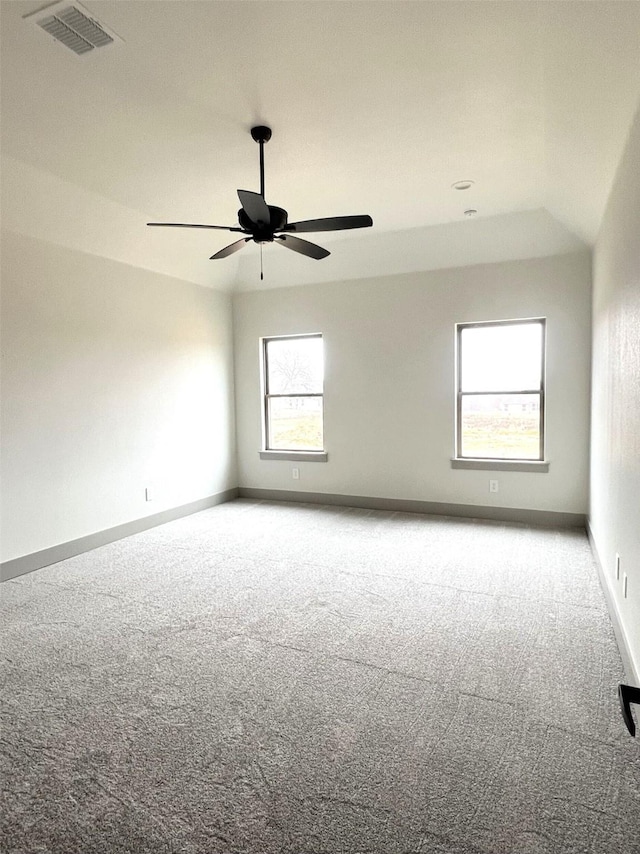 carpeted spare room with ceiling fan