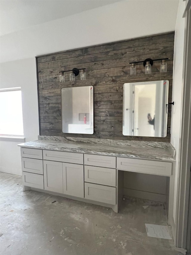 bathroom featuring vanity and wood walls