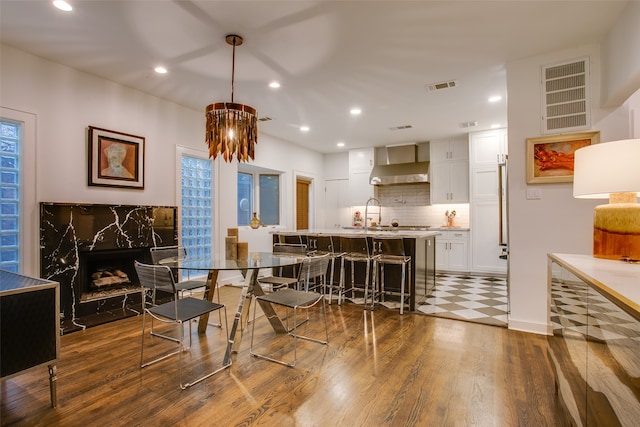 dining area with a premium fireplace and dark wood-type flooring