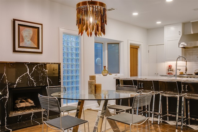 dining room featuring hardwood / wood-style floors and sink