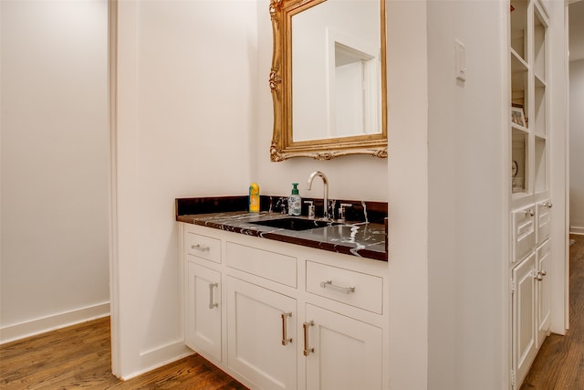 bathroom with vanity and hardwood / wood-style flooring