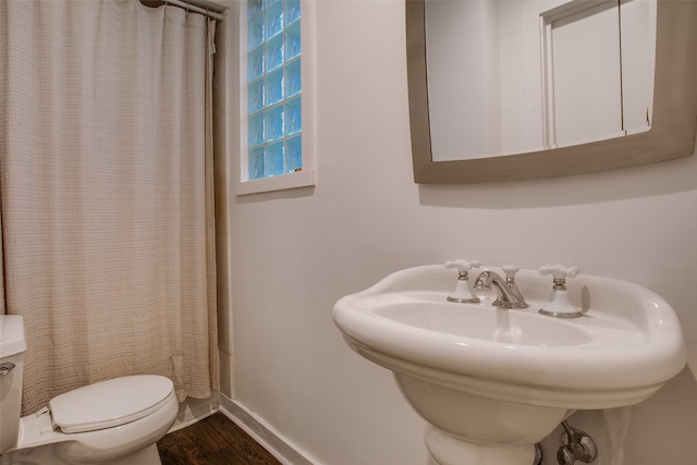 full bathroom with shower / bath combo, sink, toilet, and wood-type flooring