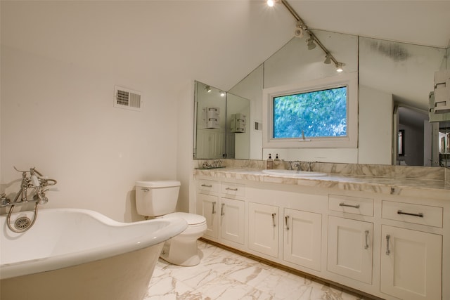 bathroom featuring track lighting, vanity, a bath, toilet, and lofted ceiling