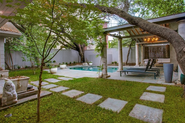 view of yard with a patio area and a fenced in pool