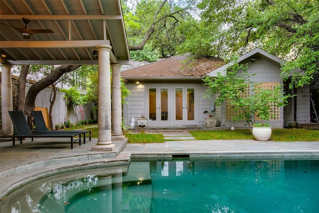 back of house featuring french doors, a patio, ceiling fan, and a pool with hot tub