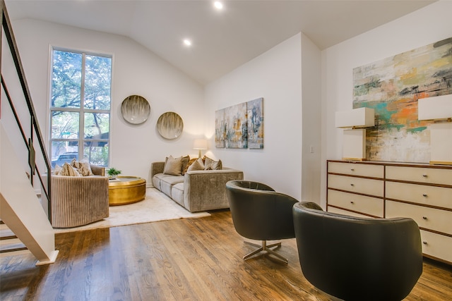 living area featuring vaulted ceiling and hardwood / wood-style flooring