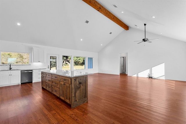 kitchen featuring white cabinetry, dark wood-type flooring, high vaulted ceiling, stainless steel dishwasher, and a kitchen island