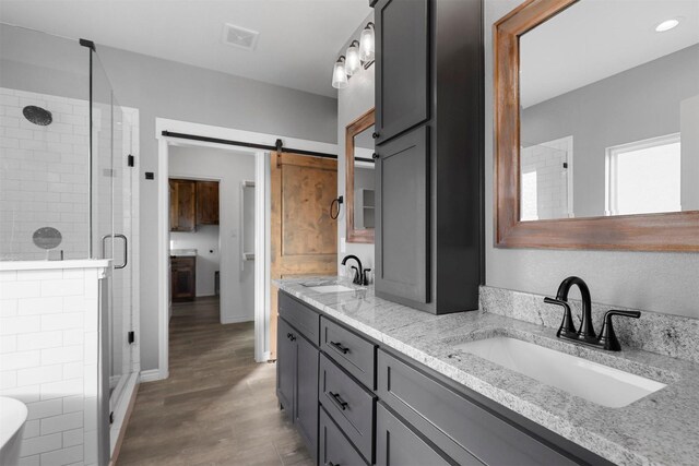 bathroom featuring vanity, hardwood / wood-style flooring, and separate shower and tub