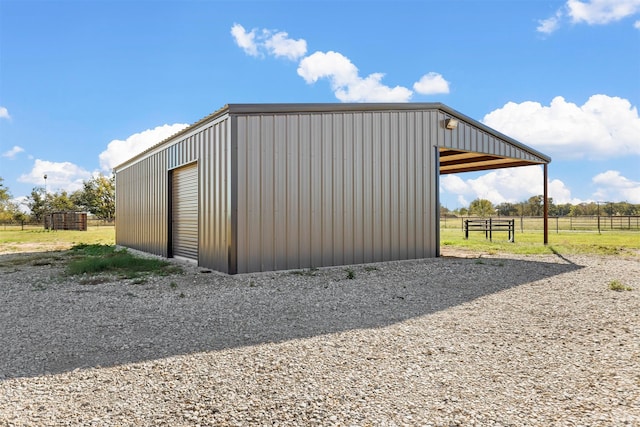 view of outdoor structure with a rural view