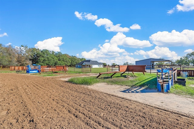 view of community featuring a rural view and an outbuilding