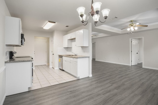 kitchen with white cabinets, dishwasher, sink, and light hardwood / wood-style flooring