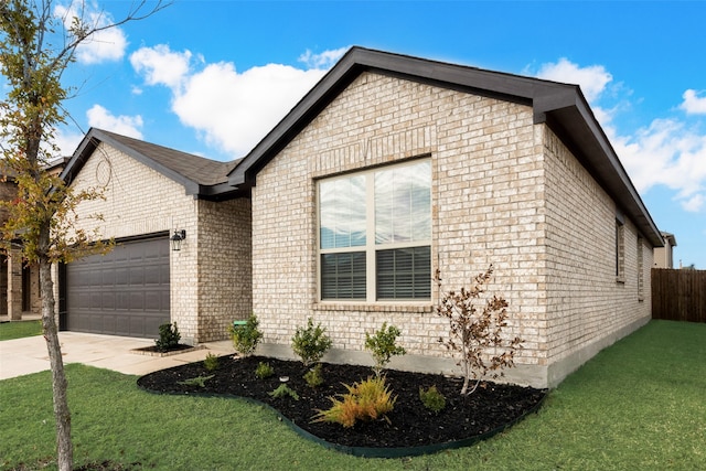 view of front of property featuring a garage and a front lawn