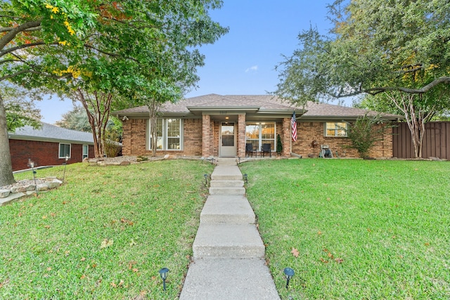 ranch-style home featuring a front yard