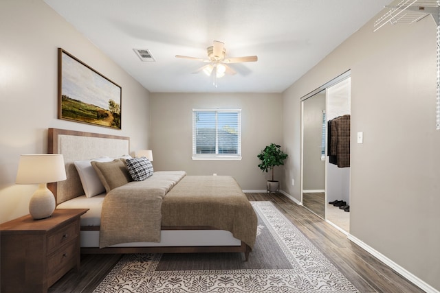 bedroom with a closet, hardwood / wood-style flooring, and ceiling fan