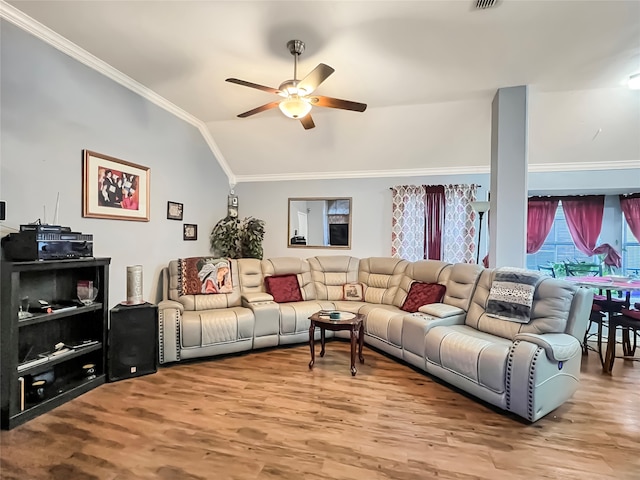 living room with lofted ceiling, ceiling fan, wood-type flooring, and crown molding