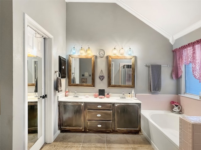 bathroom featuring vanity, lofted ceiling, a bath, tile patterned flooring, and ornamental molding