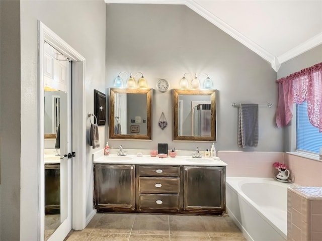 bathroom featuring crown molding, tile patterned flooring, vanity, vaulted ceiling, and a bathing tub